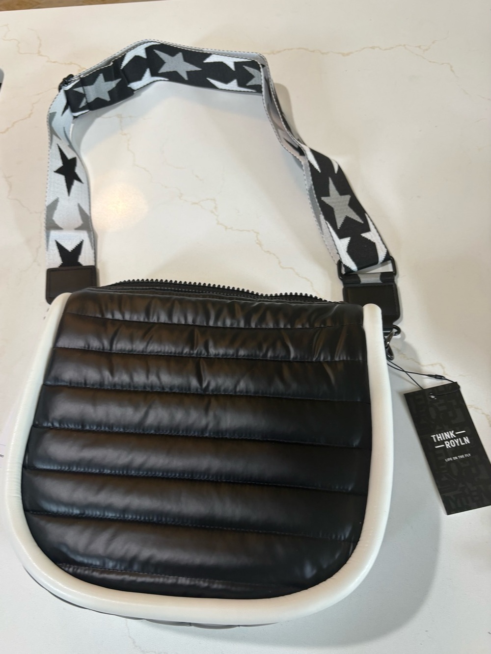 Think Royln Nordic crossbody, black with white trim and a bold star strap